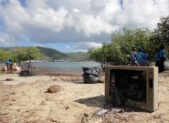 Young eco caregivers scrub polluted Tortola coastlines